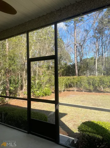 a view of a glass door with a yard