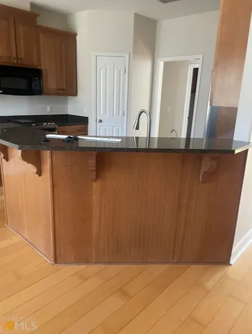 a view of kitchen with wooden floor