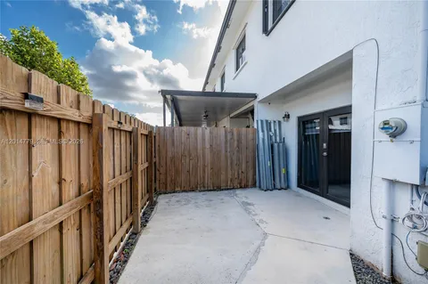 a view of a house with wooden fence