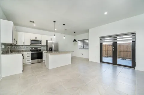 a large kitchen with cabinets and stainless steel appliances