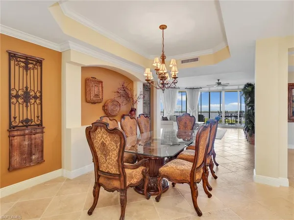 a view of a dining room with furniture and chandelier