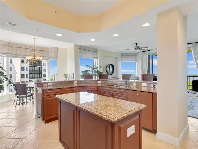 a kitchen with kitchen island granite countertop a sink and counter