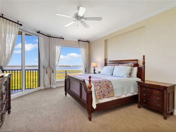 a spacious bedroom with a bed and a chandelier