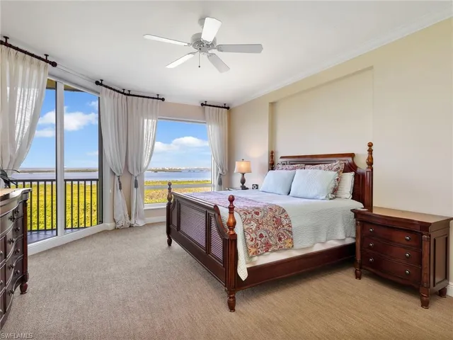 a spacious bedroom with a bed and a chandelier