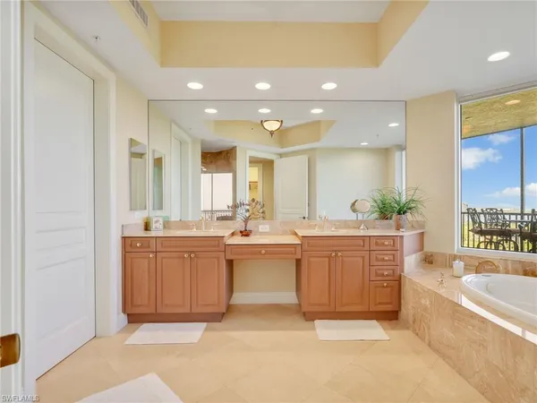 a large bathroom with a large tub vanity and sink