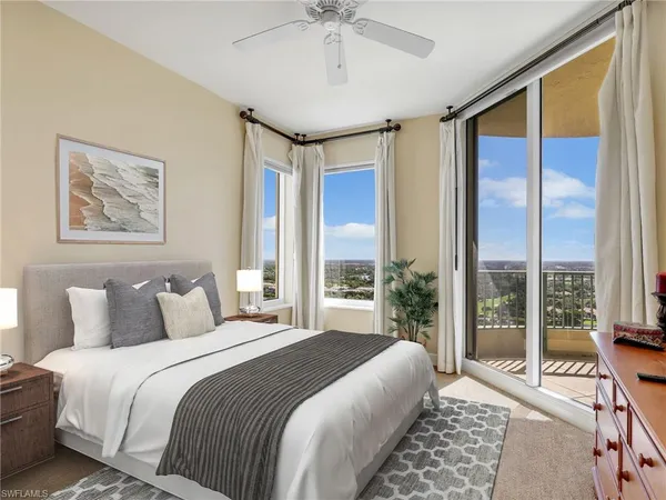 a bedroom with a large bed and a chandelier