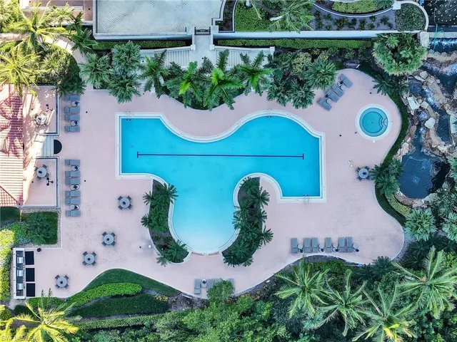 an aerial view of a house with a yard and outdoor seating