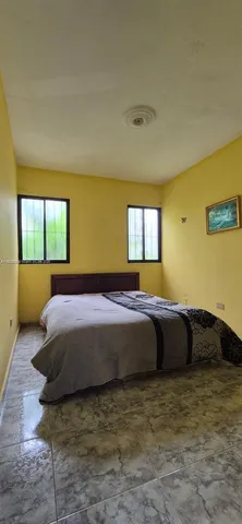 a spacious bedroom with a bed and window