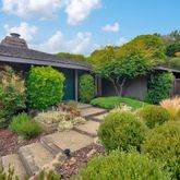 a view of a chair and table in the backyard