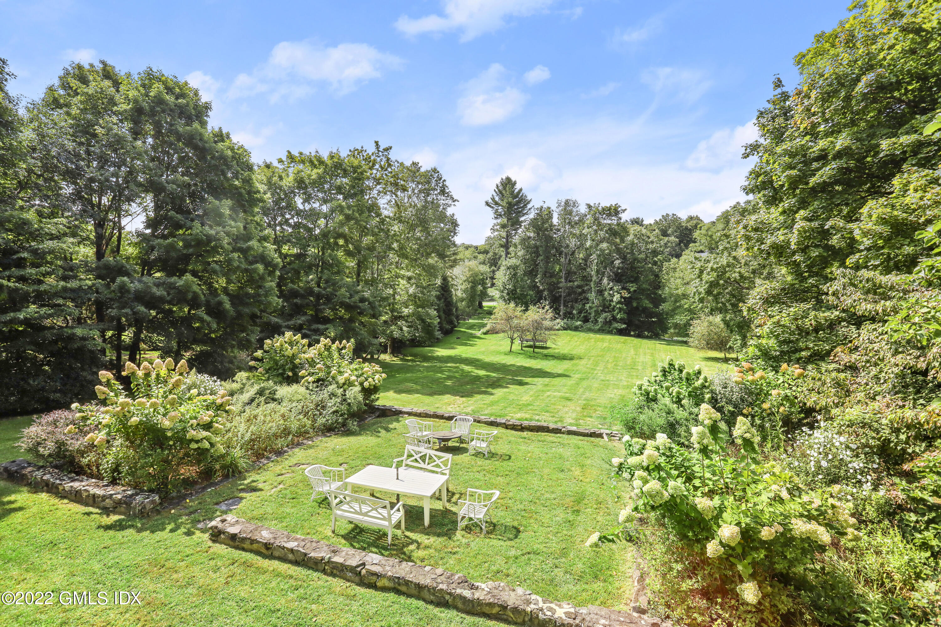 121 Clapboard Ridge Road Greenwich, CT 06830 - Photo 3 of 23 a view of a grassy area with an trees
