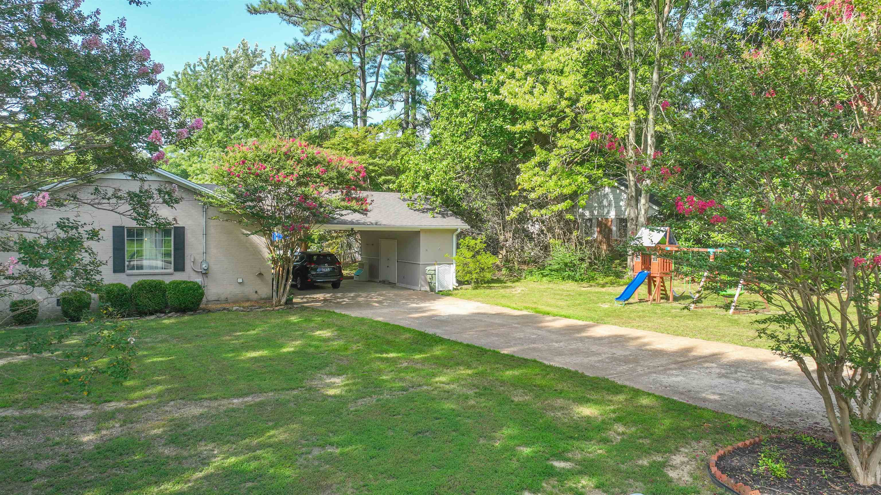 129 Thompson Drive Ripley, TN 38063 - Photo 7 of 22 a view of a house with backyard and a tree