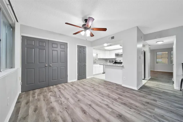 a view of a kitchen with wooden floor and a kitchen