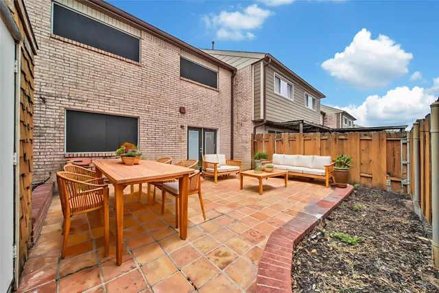 a backyard of a house with table and chairs