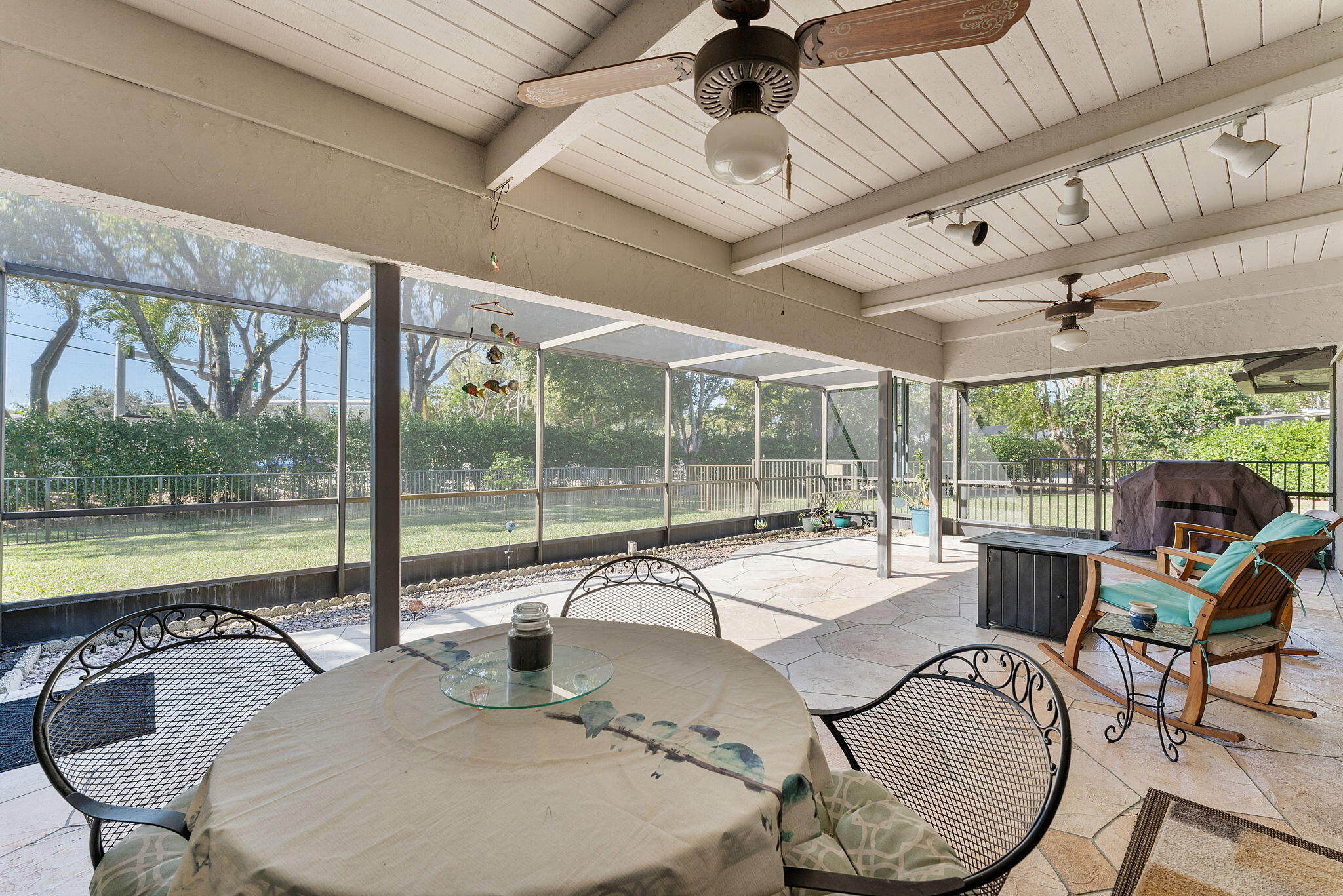 6206 Springdale Way Delray Beach, FL 33484 - Photo 18 of 38 a patio with a table chairs and a swimming pool