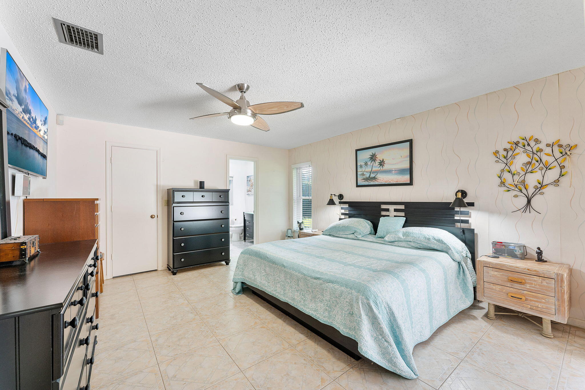 6206 Springdale Way Delray Beach, FL 33484 - Photo 34 of 38 a bedroom with a bed and a refrigerator
