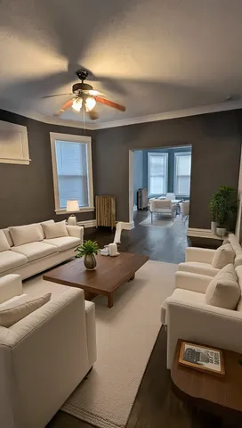 a living room with furniture and a chandelier