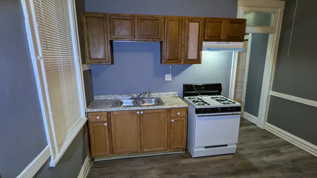 a kitchen with stainless steel appliances granite countertop a refrigerator and a stove