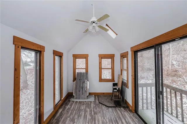 a view of a hallway with a window and wooden floor