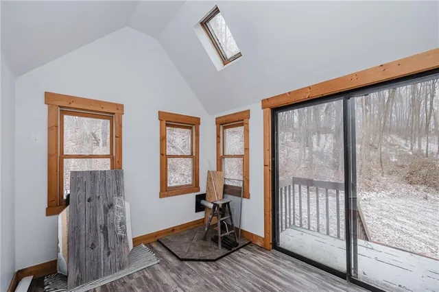 a room with wooden floor and a window