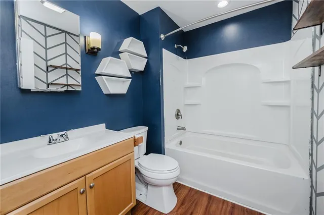 a bathroom with a sink a toilet and bathtub