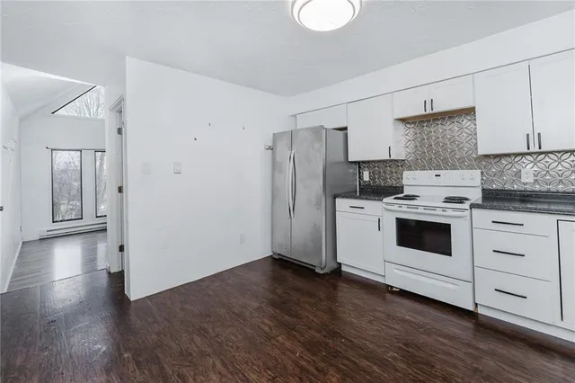 a kitchen with stainless steel appliances a stove a refrigerator and cabinets