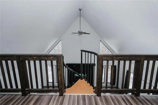 a view of hallway with wooden floor and stairs