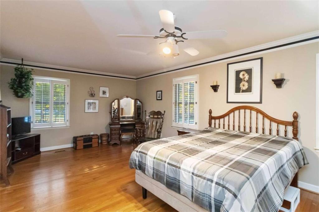 5888 Old Stone Mountain Road Stone Mountain, GA 30087 - Photo 14 of 61 a bedroom with a bed and wooden floor