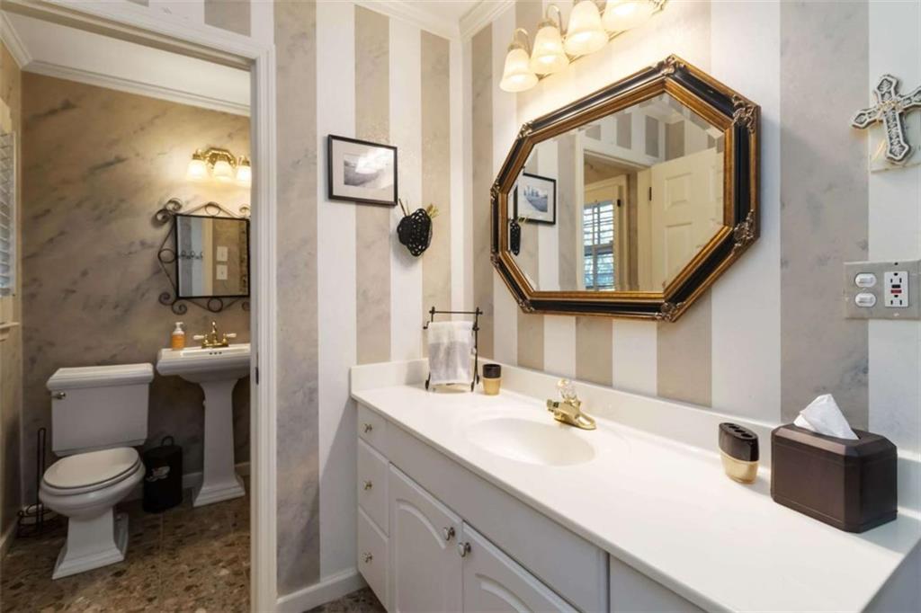 5888 Old Stone Mountain Road Stone Mountain, GA 30087 - Photo 16 of 61 a bathroom with a toilet sink and mirror