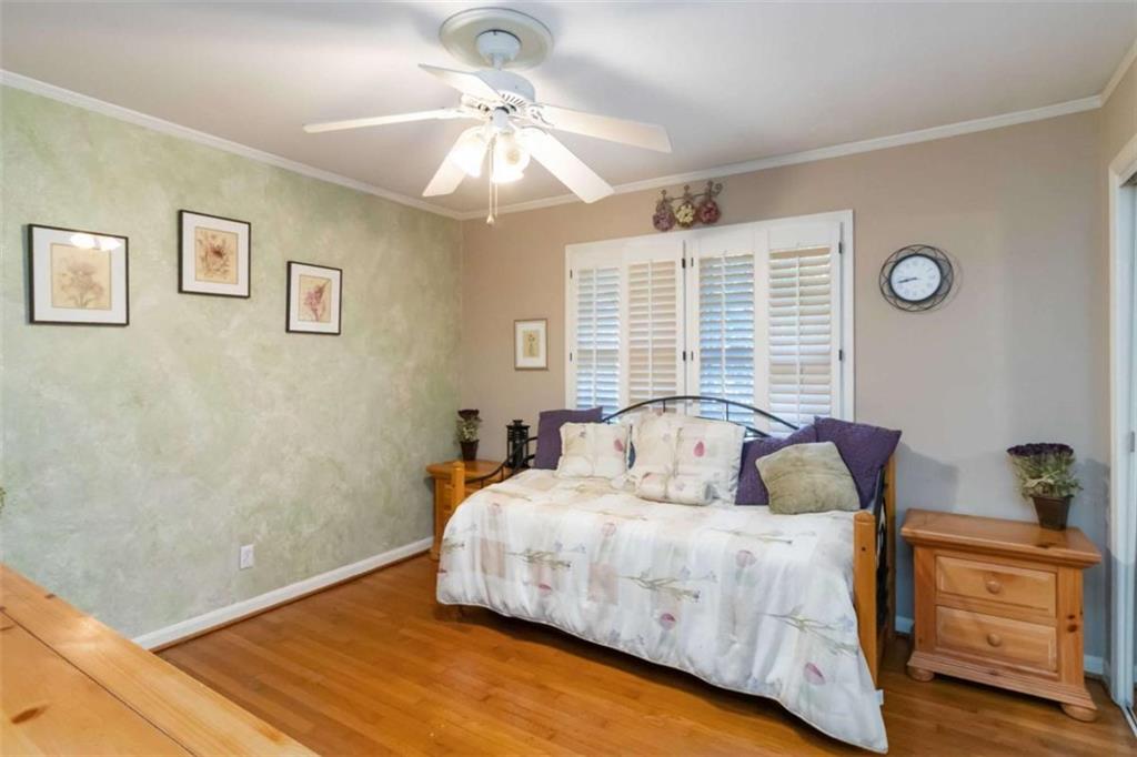 5888 Old Stone Mountain Road Stone Mountain, GA 30087 - Photo 21 of 61 a bedroom with a large bed and a chandelier