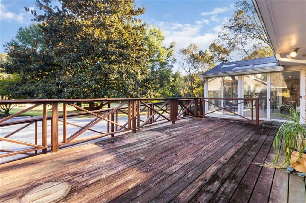 5888 Old Stone Mountain Road Stone Mountain, GA 30087 - Photo 26 of 61 a view of a balcony with wooden floor and outdoor seating
