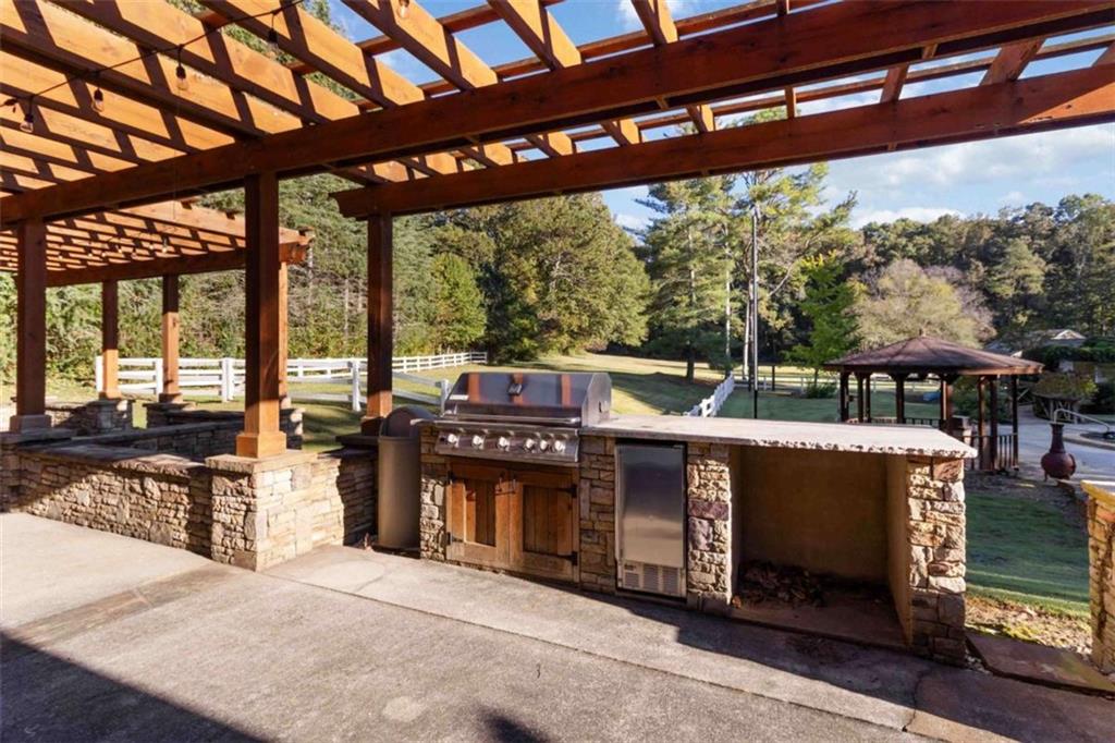 5888 Old Stone Mountain Road Stone Mountain, GA 30087 - Photo 31 of 61 a view of a porch with chairs and backyard
