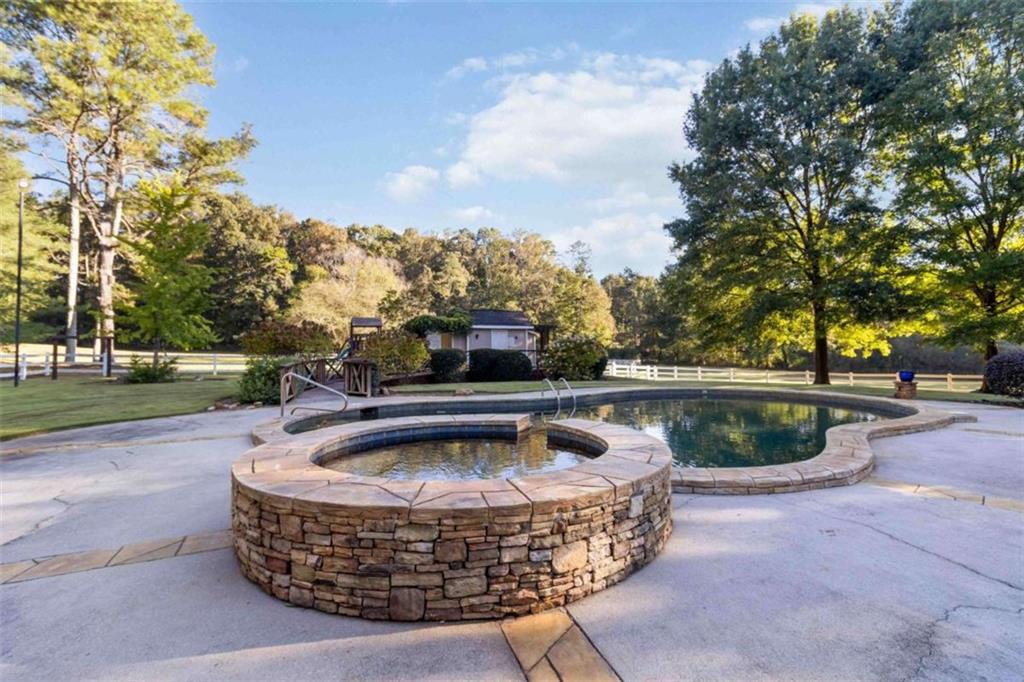 5888 Old Stone Mountain Road Stone Mountain, GA 30087 - Photo 33 of 61 a view of swimming pool with outdoor seating and plants