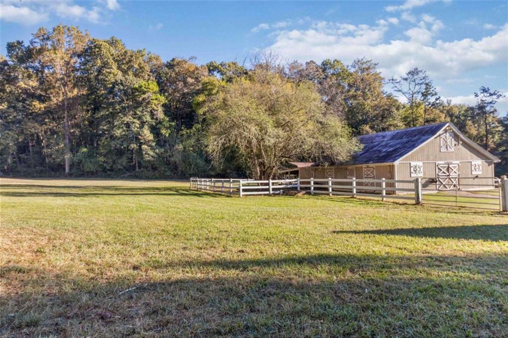 5888 Old Stone Mountain Road Stone Mountain, GA 30087 - Photo 38 of 61 a view of a house with pool and a yard