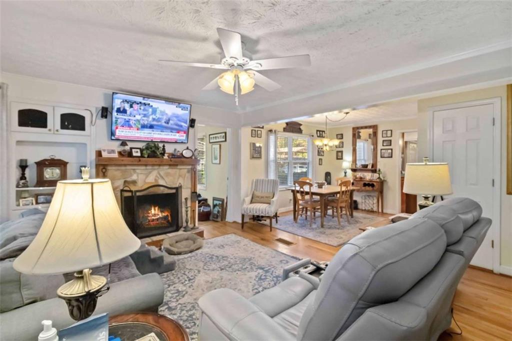 5888 Old Stone Mountain Road Stone Mountain, GA 30087 - Photo 43 of 61 a living room with furniture a flat screen tv and a fireplace
