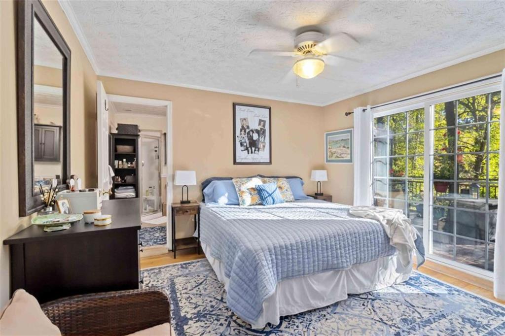 5888 Old Stone Mountain Road Stone Mountain, GA 30087 - Photo 50 of 61 a bedroom with a bed and a chandelier