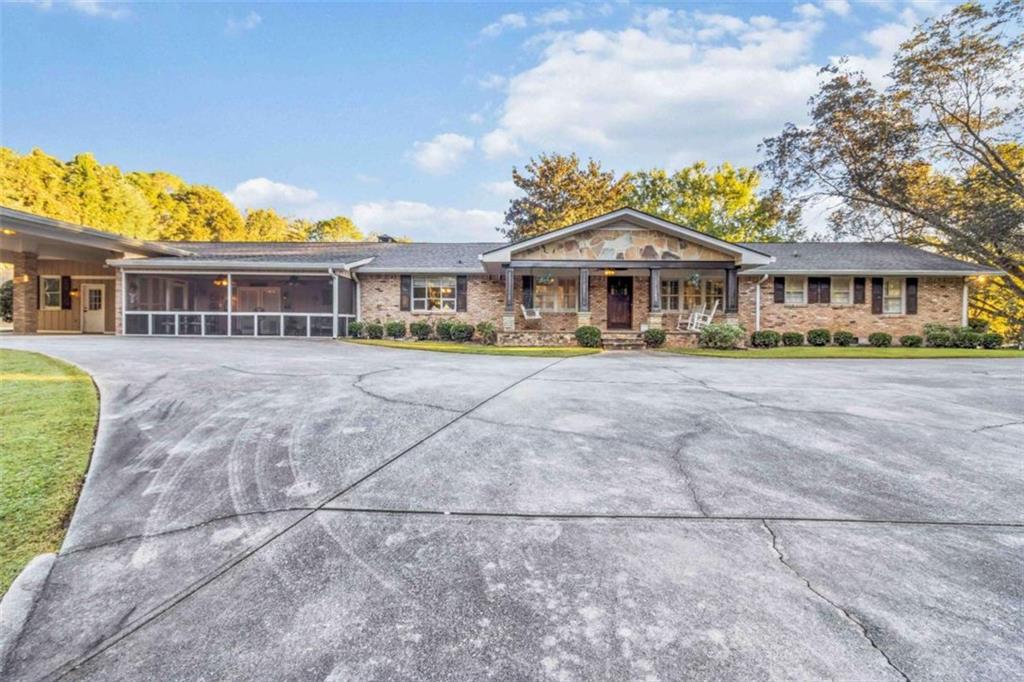 5888 Old Stone Mountain Road Stone Mountain, GA 30087 - Photo 5 of 61 a front view of a house with a yard and trees