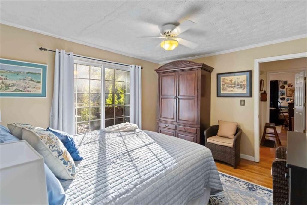 5888 Old Stone Mountain Road Stone Mountain, GA 30087 - Photo 51 of 61 a bedroom with a bed and wooden cabinets