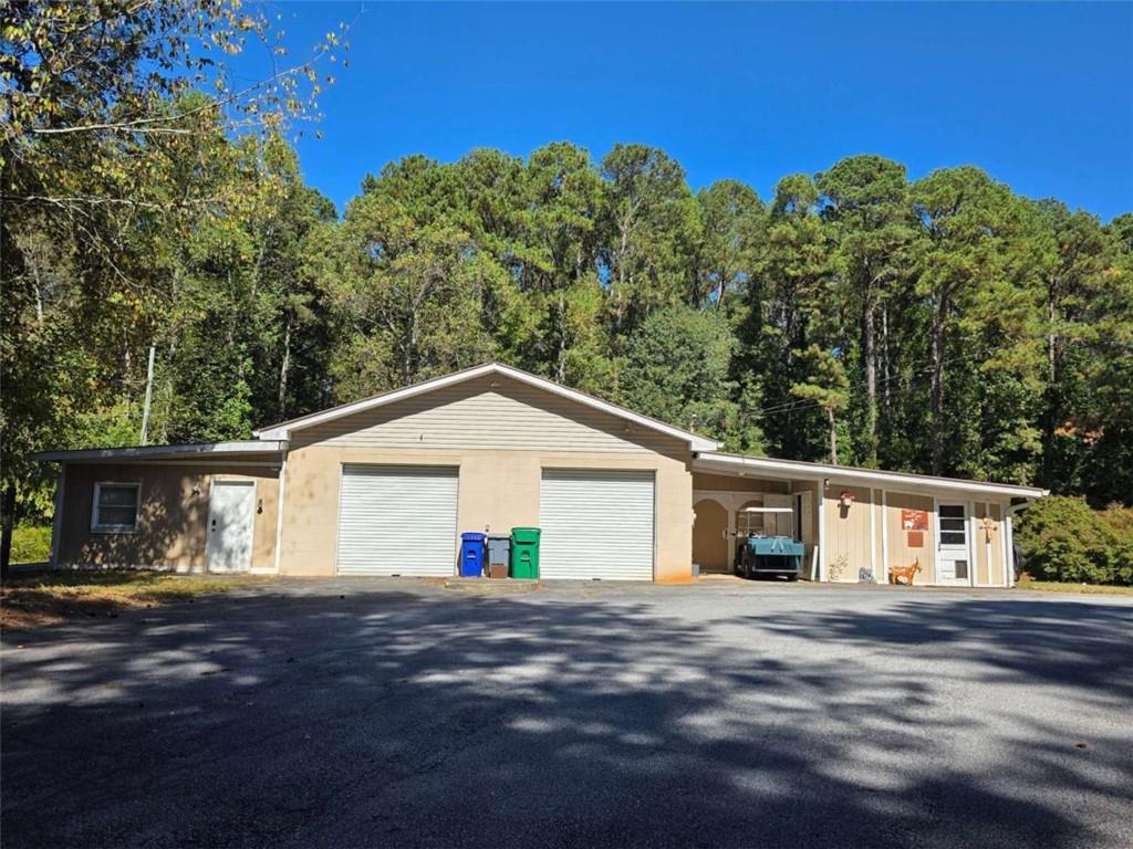 5888 Old Stone Mountain Road Stone Mountain, GA 30087 - Photo 58 of 61 a front view of a house with a yard and garage