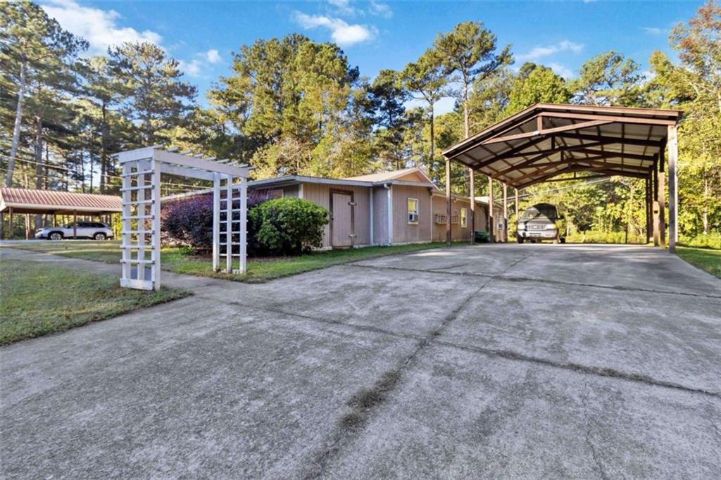 5888 Old Stone Mountain Road Stone Mountain, GA 30087 - Photo 61 of 61 a view of a house with a yard and garage