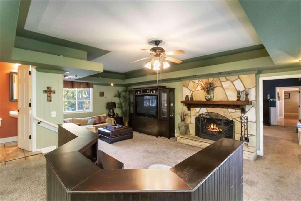5888 Old Stone Mountain Road Stone Mountain, GA 30087 - Photo 8 of 61 a living room with fireplace furniture and a large window