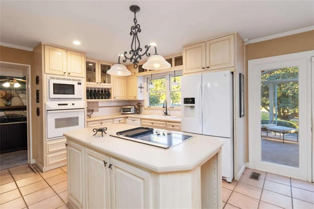 5888 Old Stone Mountain Road Stone Mountain, GA 30087 - Photo 9 of 61 a kitchen with stainless steel appliances a stove a refrigerator a sink and white cabinets