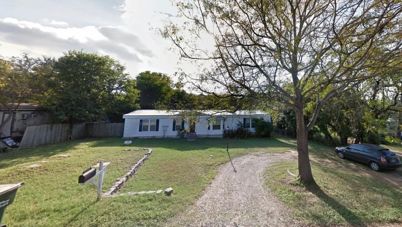 1102 Castile Road Austin, TX 78733 - Photo 1 of 1 a view of a backyard with a small cabin