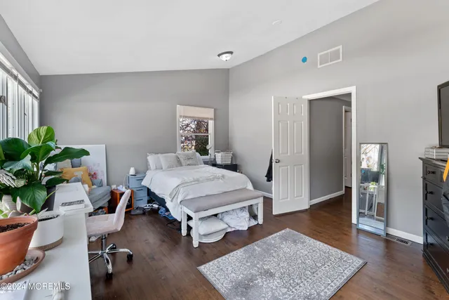 a bedroom with furniture and a rug