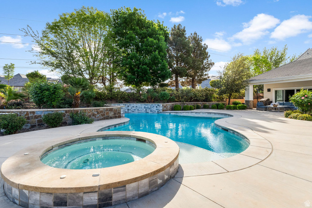 2917 Old Farm Road Washington, UT 84780 - Photo 25 of 105 View of pool with patio surround, a fenced backyard, and an in-ground hot tub