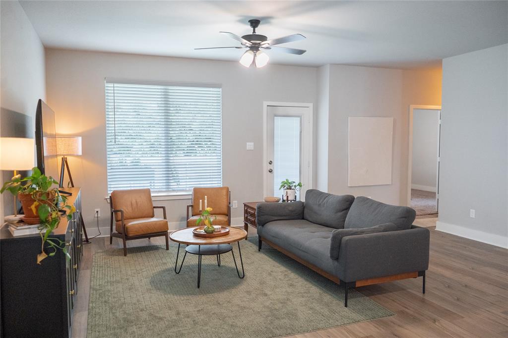 7909 Townsend Drive Waco, TX 76708 - Photo 9 of 22 Spacious living area featuring wood-finish flooring, light grey wall paint, and a ceiling fan