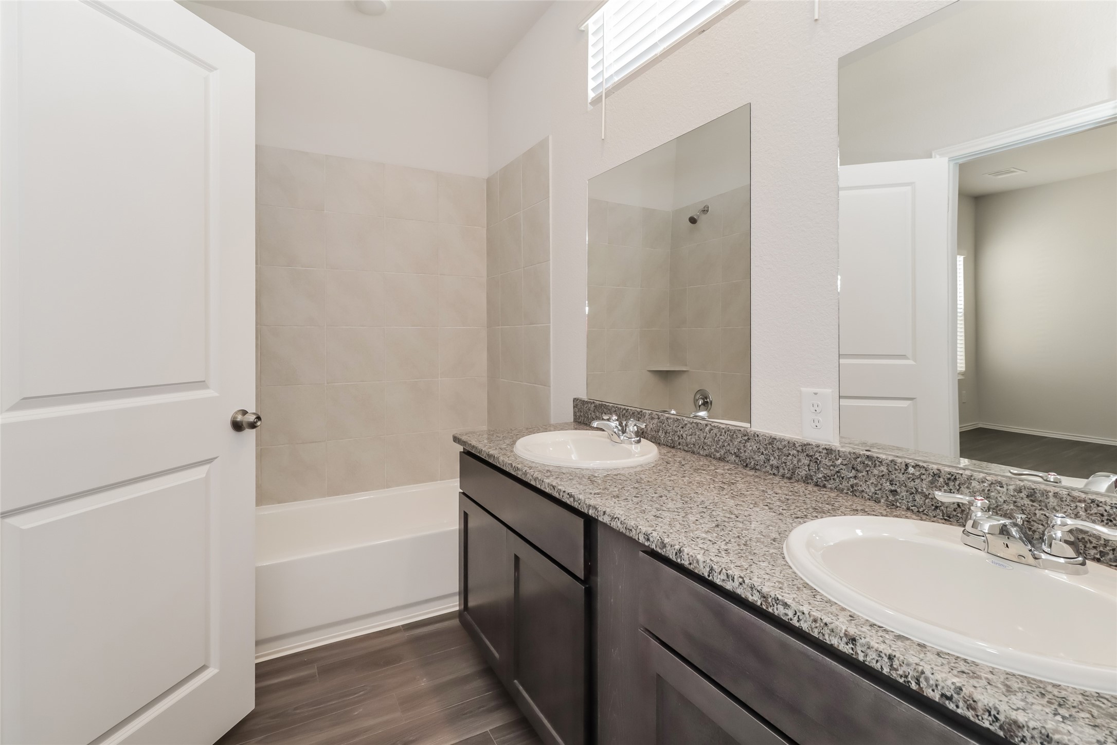 15322 Estrella Road West Houston, TX 77073 - Photo 12 of 16 a bathroom with a granite countertop tub sink and mirror