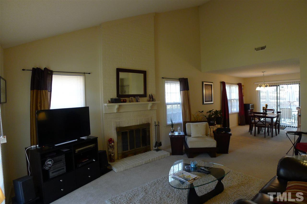 2708 Heathersmith Court Raleigh, NC 27604 - Photo 2 of 25 a living room with furniture a flat screen tv and a fireplace