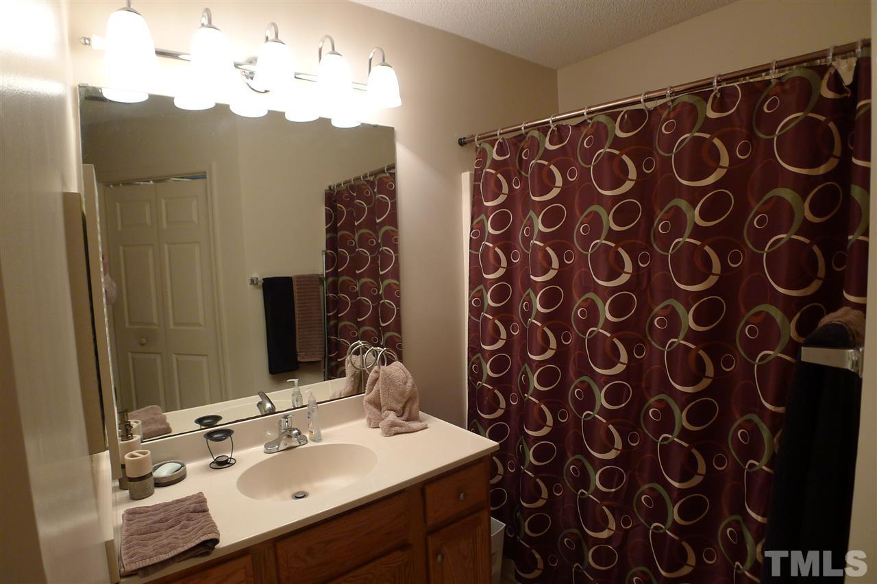 2708 Heathersmith Court Raleigh, NC 27604 - Photo 11 of 25 a bathroom with a sink and a mirror