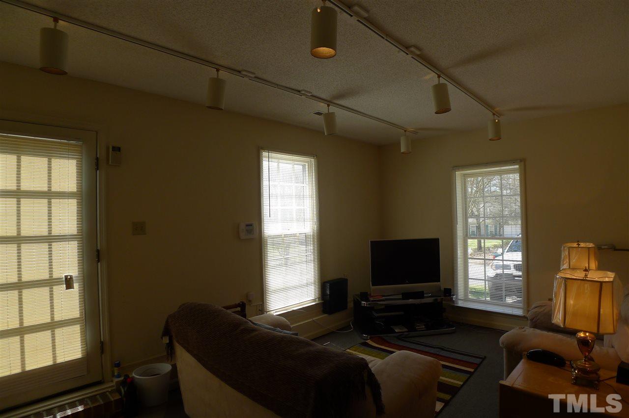 2708 Heathersmith Court Raleigh, NC 27604 - Photo 12 of 25 a living room with furniture and a flat screen tv