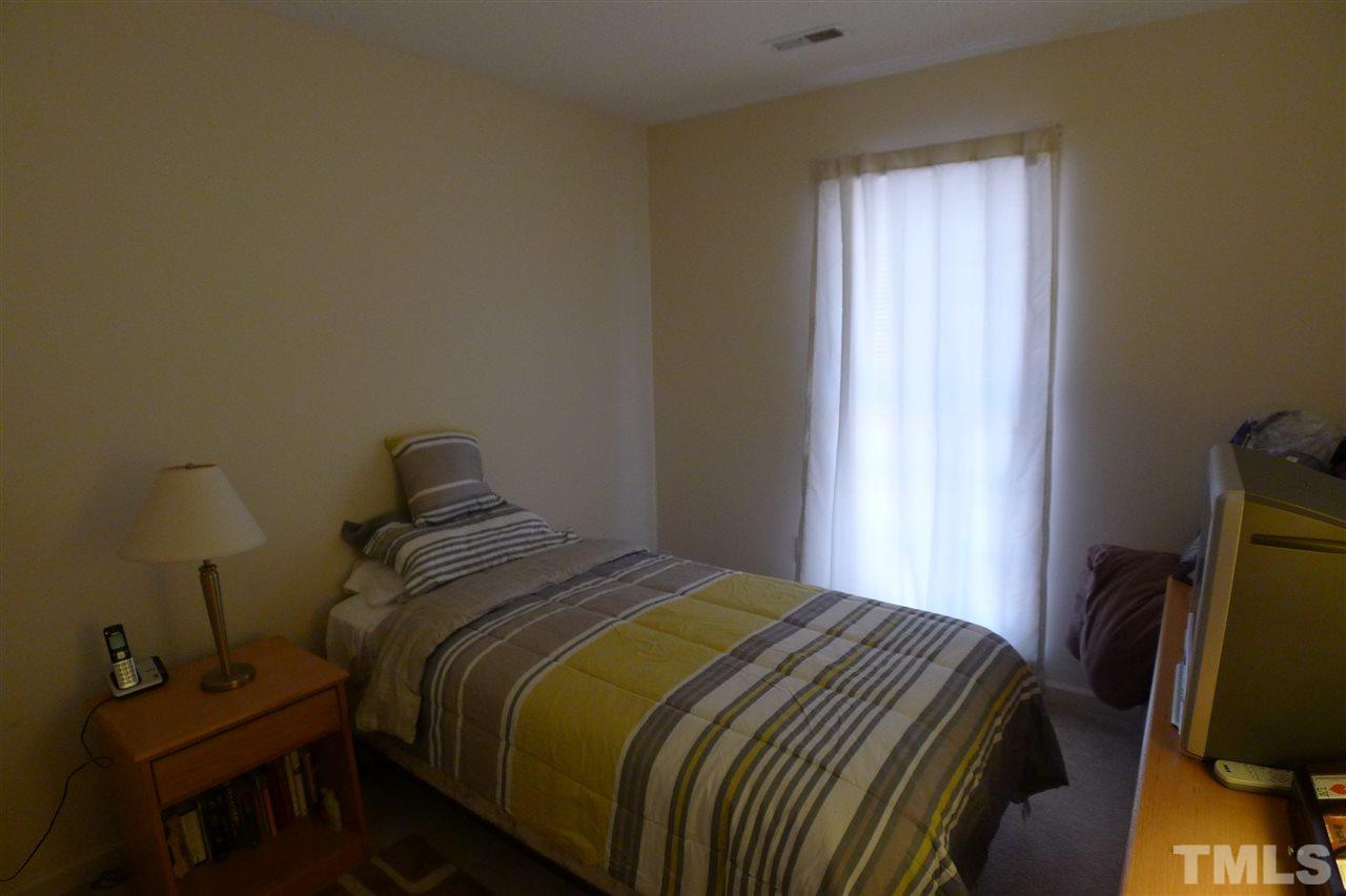 2708 Heathersmith Court Raleigh, NC 27604 - Photo 14 of 25 a bedroom with a bed next to a window